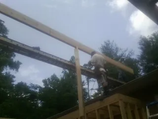 Carpenter setting a ridge beam over a new addition frame — Ice Dam Removal by Roofing Brothers in Idaho Falls