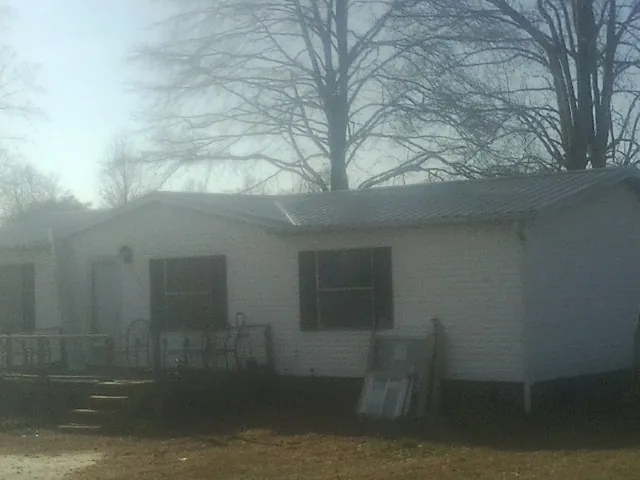 New metal roof on a white painted brick home on a foggy morning in Idaho Falls